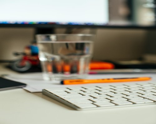 Glass of water with lemon on a modern working desk
